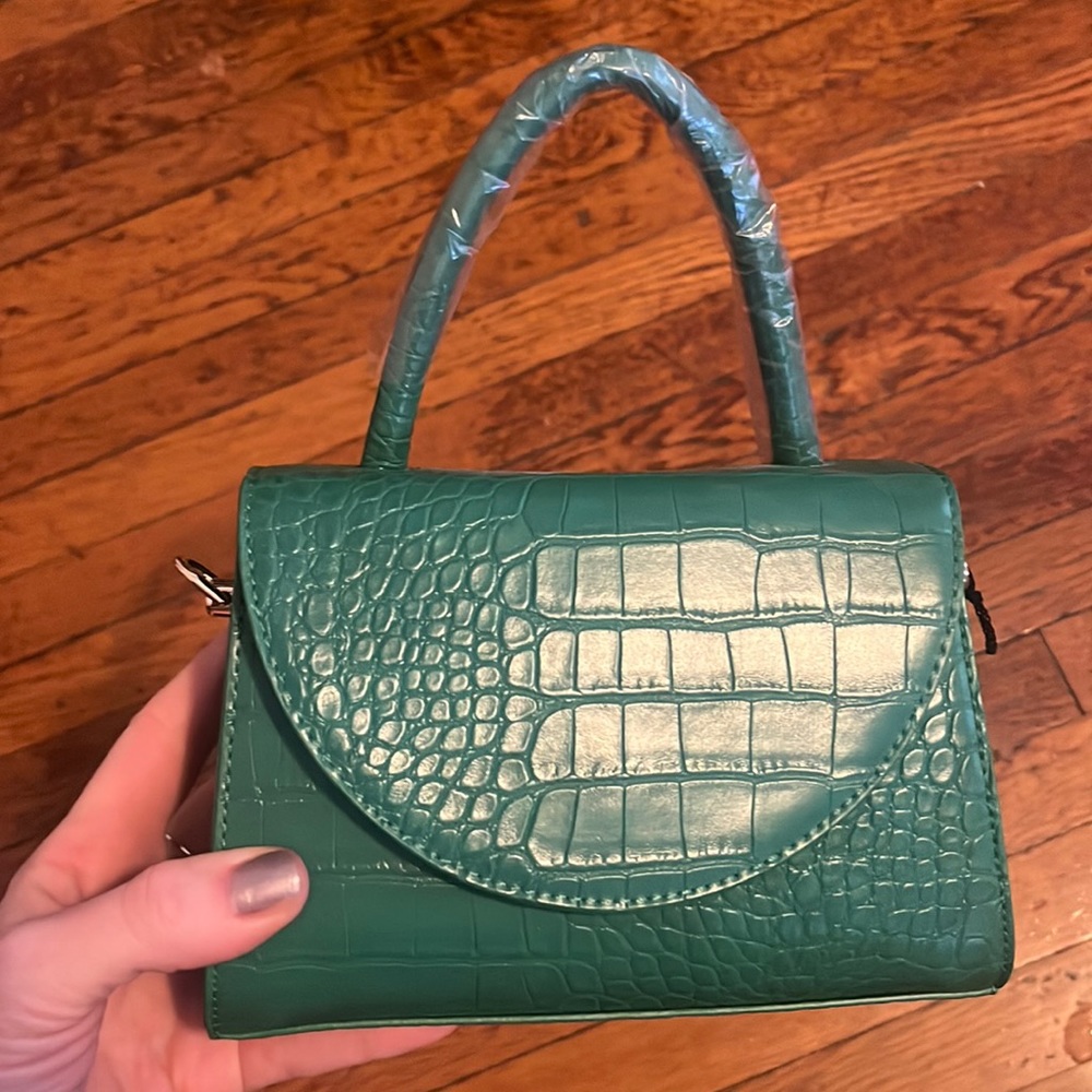 Never worn green top handle bag, with strap.